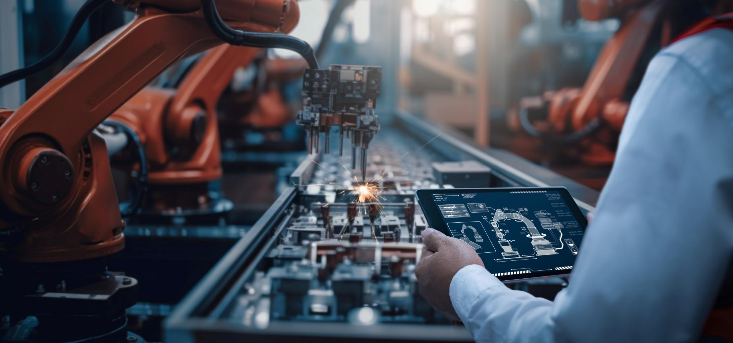 Tech worker overseeing robotic arm project